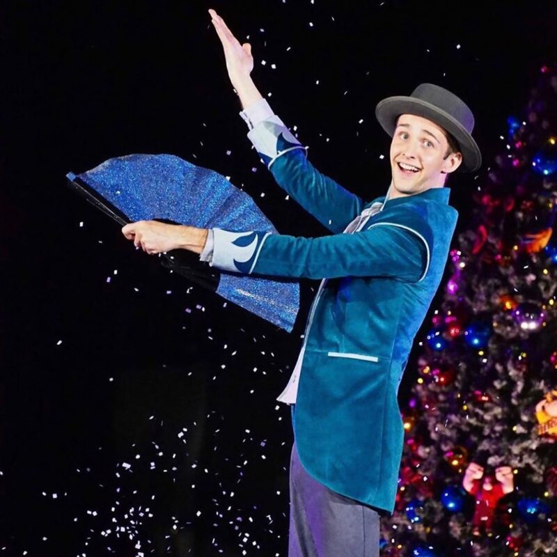 childrens entertainer making snow appear in Christmas magic show