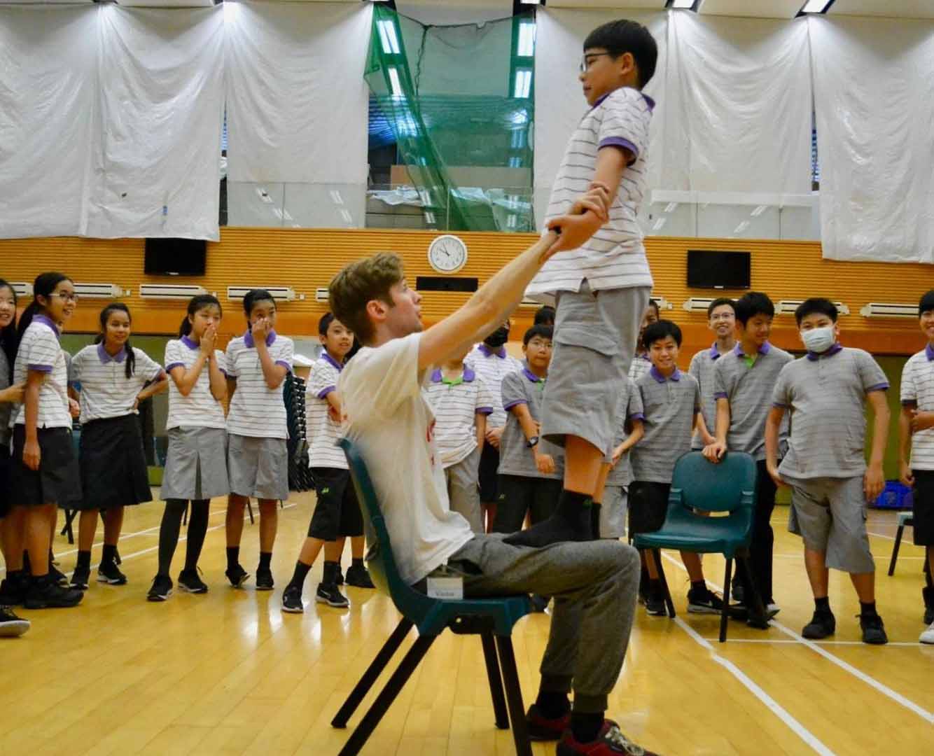 child learning circus tricks in a school circus workshop